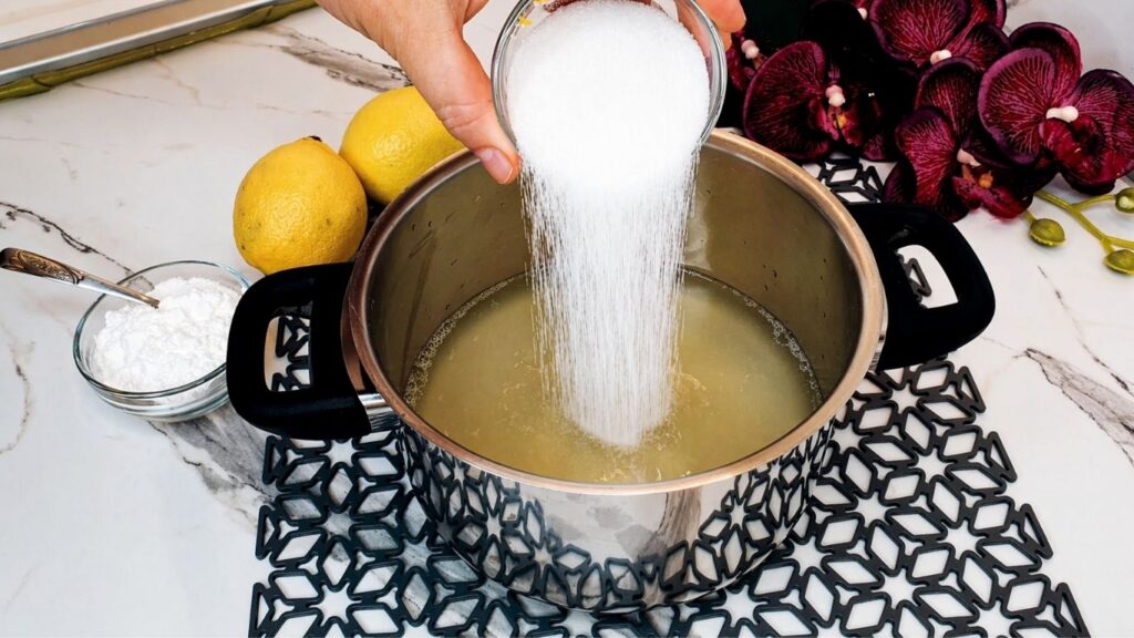 Cooking the lemon glaze for the top of the no-bake lemon cake