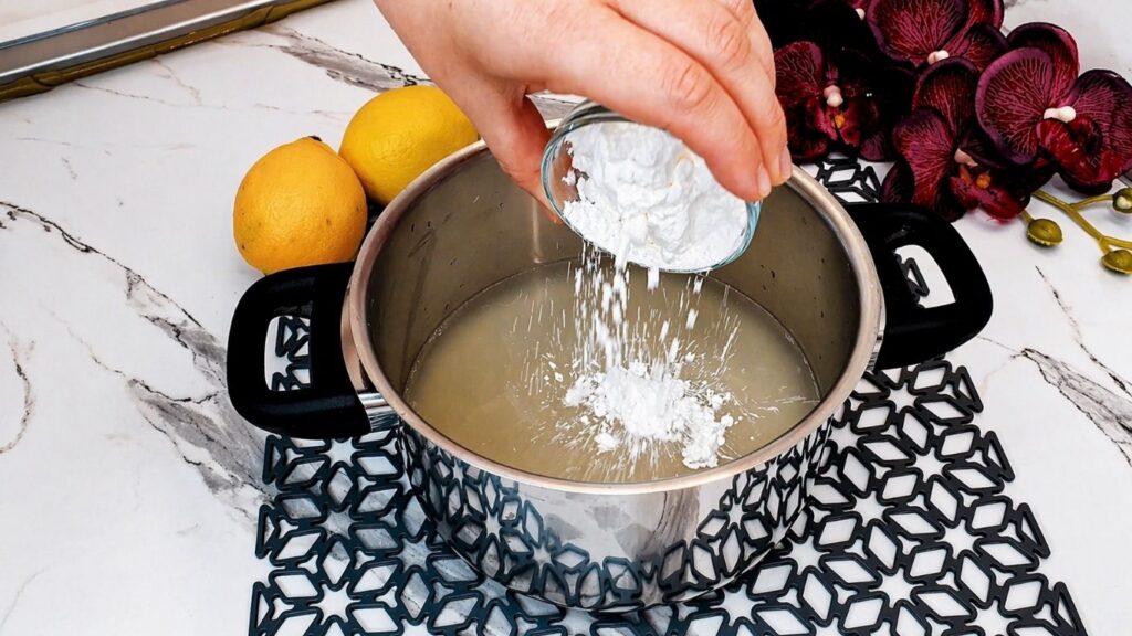 Cooking the lemon glaze for the top of the no-bake lemon cake