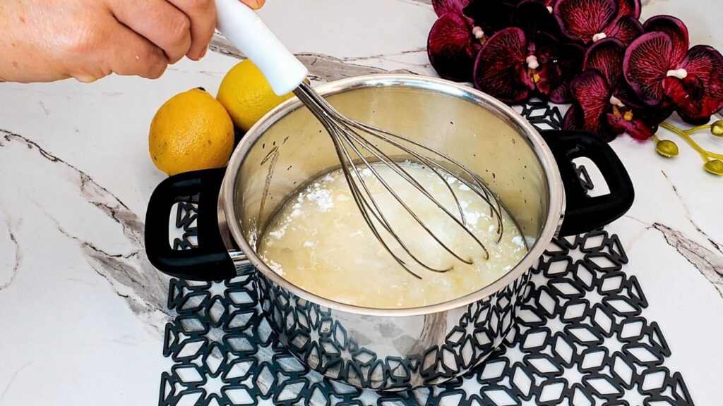 Cooking the lemon glaze for the top of the no-bake lemon cake