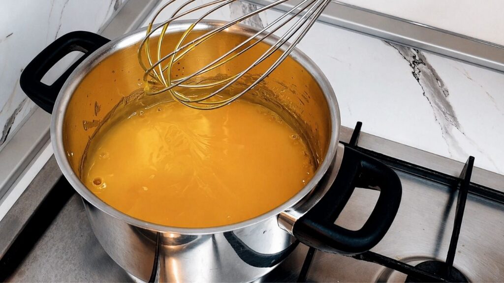 Cooking the lemon glaze for the top of the no-bake lemon cake
