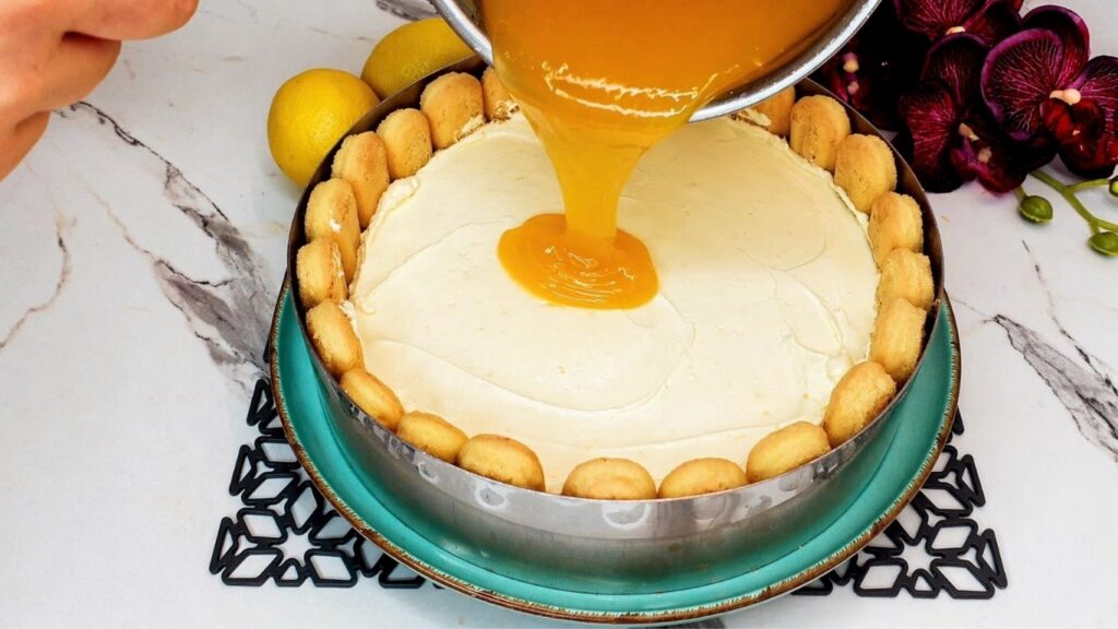 Pouring lemon glaze over the top of the no-bake lemon cake