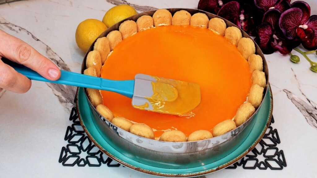 Pouring lemon glaze over the top of the no-bake lemon cake