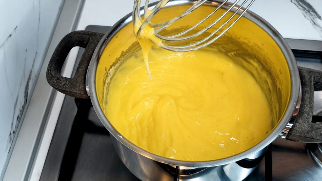 Cooked cream filling for no-bake lemon cake after thickening on the stove