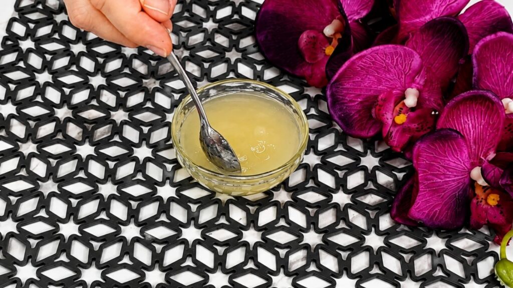 Bloomed gelatin soaking in cold water for no bake raspberry yogurt cake recipe preparation