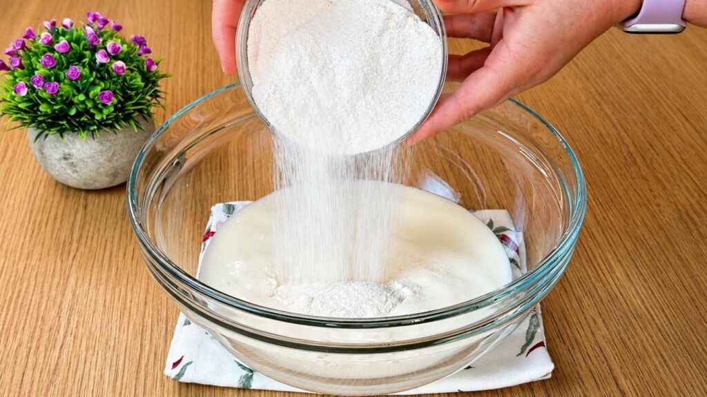 Adding vanilla cream powder, powdered sugar, and vanilla sugar into cold milk for easy strawberry cake filling