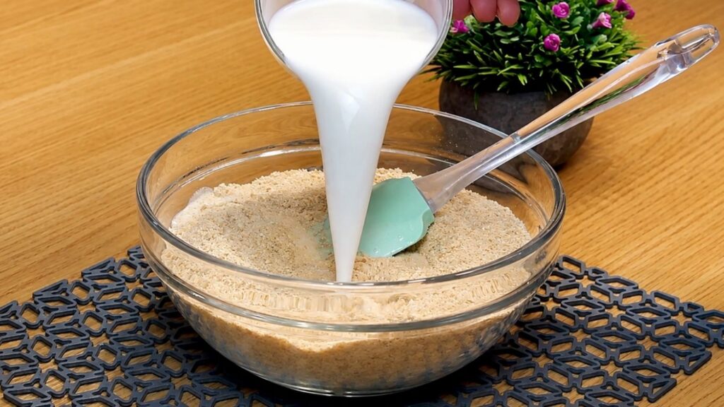 Mixing ground cookies with milk to make the crust, then pressing the crumb mixture evenly into a 24 cm (9.5-inch) springform pan.