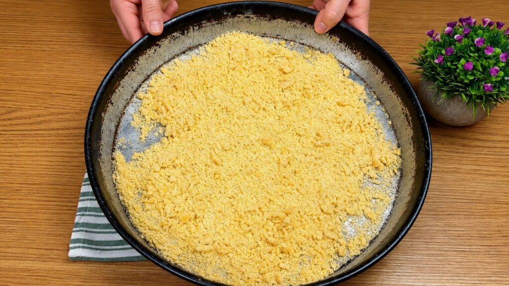Homemade pastry crumbs prepared in a baking pan for crispy baklava recipe.