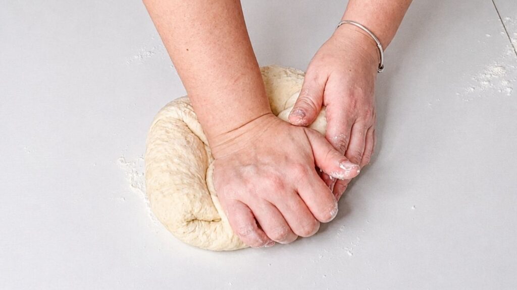 Mixing soft dough in a bowl and kneading it on a work surface.