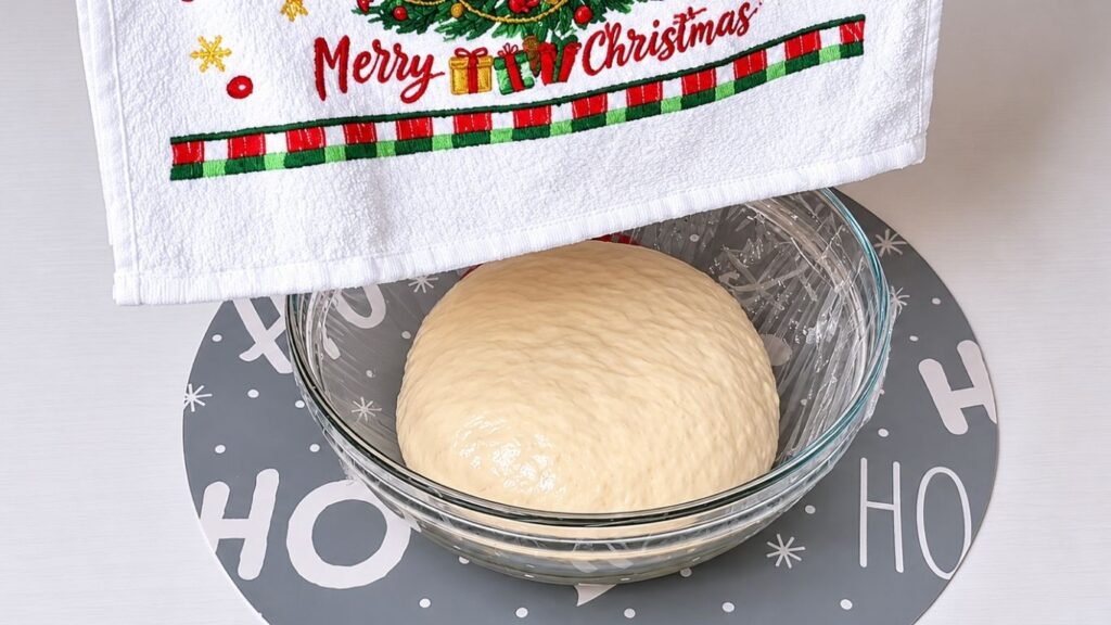 Kneaded dough placed in a lightly oiled bowl to rise.