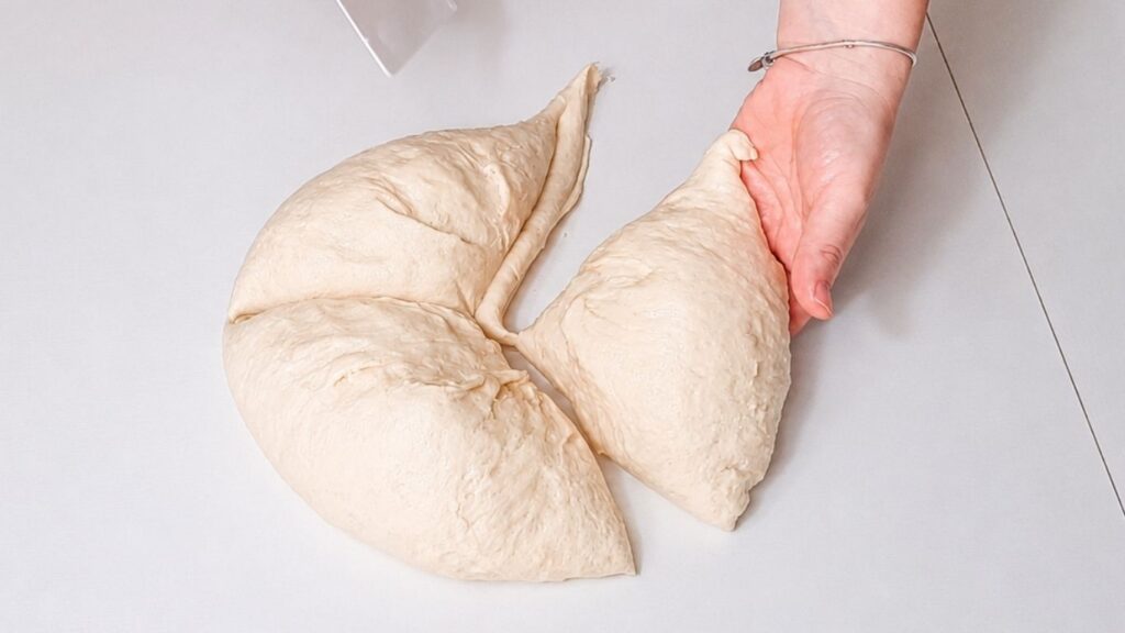 Dough divided into three equal pieces for shaping a Christmas bread wreath.