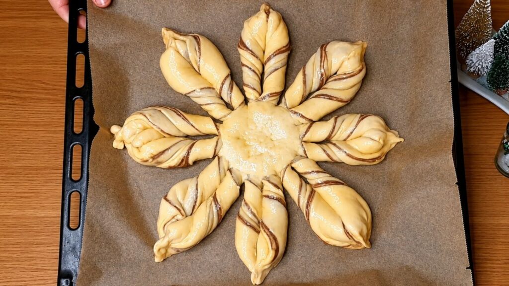 Freshly baked chocolate star bread on a baking sheet, golden brown and puffed to perfection