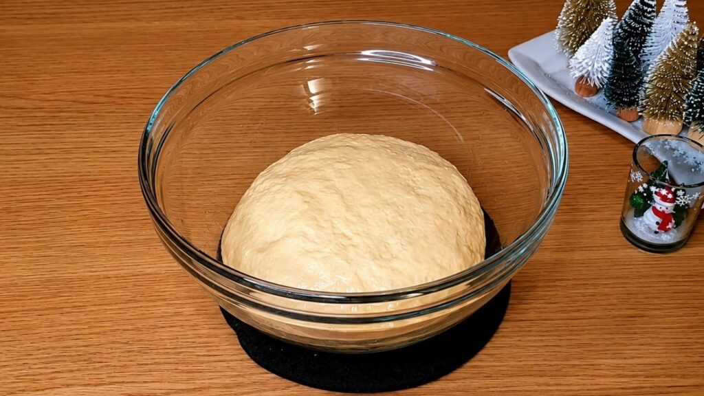 Soft chocolate star bread dough resting in a lightly oiled bowl before rising.
