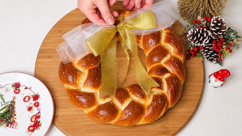 Soft golden Christmas bread wreath served on a holiday table.