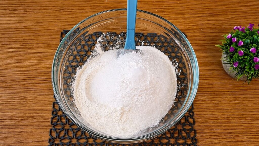 Dry ingredients for vanilla sponge cake mixed together in a large bowl.