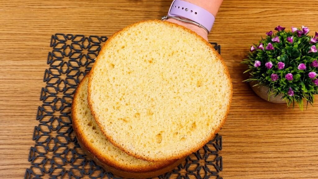 Sliced vanilla sponge cake layers showing a soft and fluffy crumb inside.