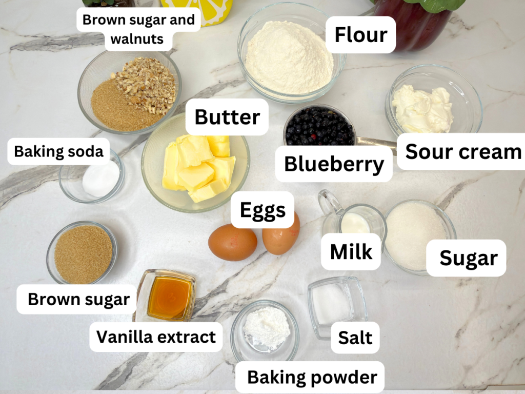 Ingredients for homemade blueberry muffins arranged on a table
