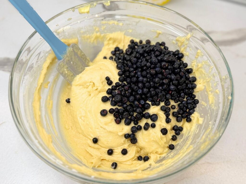Blueberries added to the homemade muffin batter