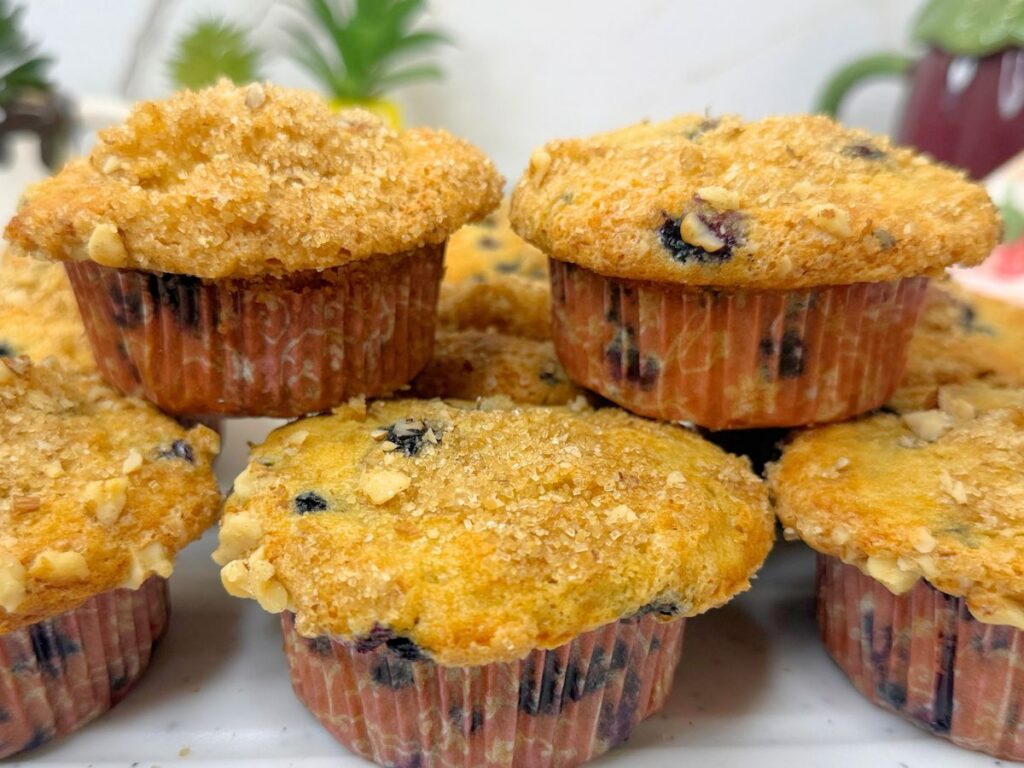 These soft and moist blueberry muffins are packed with juicy blueberries and finished with a crunchy brown sugar, walnut, and cinnamon topping. Perfect for breakfast, brunch, or a sweet afternoon treat.