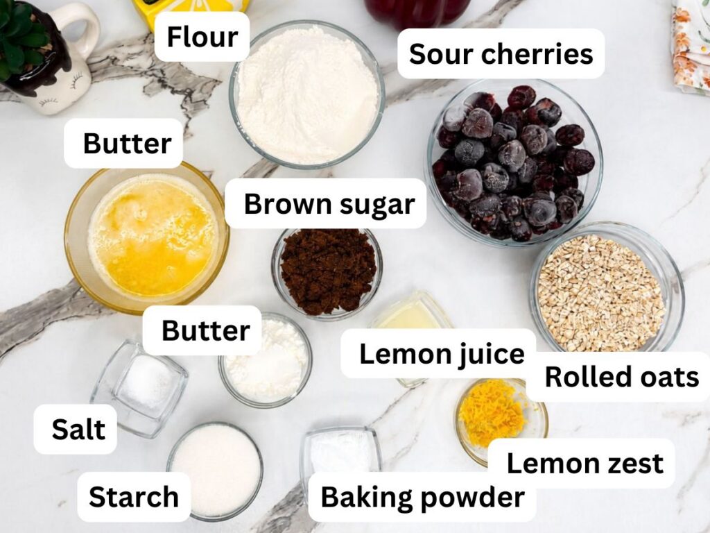 Ingredients for homemade cherry crumb bars arranged on a table.