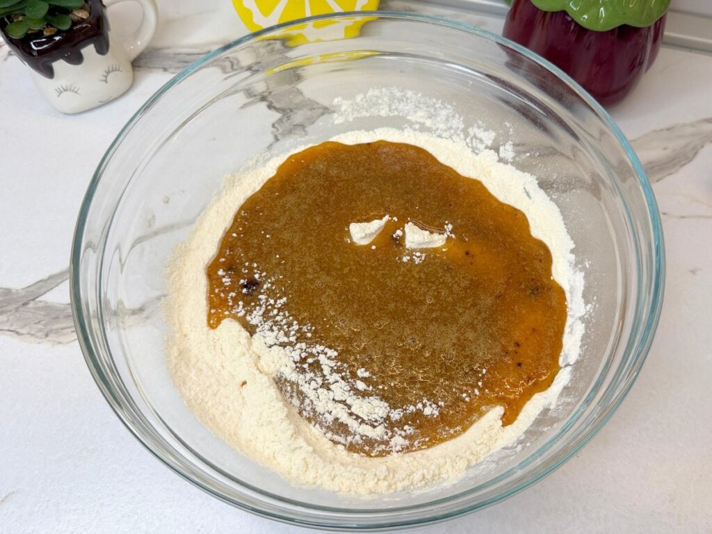 Wet and dry ingredients in separate bowls for chocolate chip cookie bars.