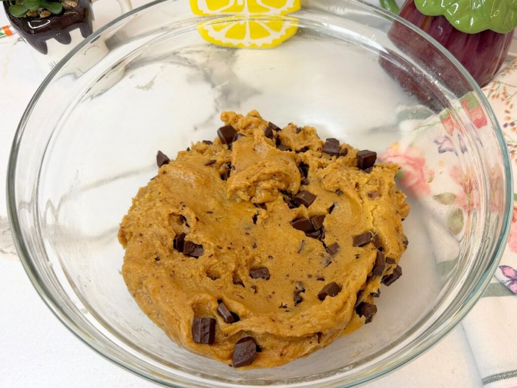Chocolate chip cookie bar dough mixed with chocolate chips and ready to chill.