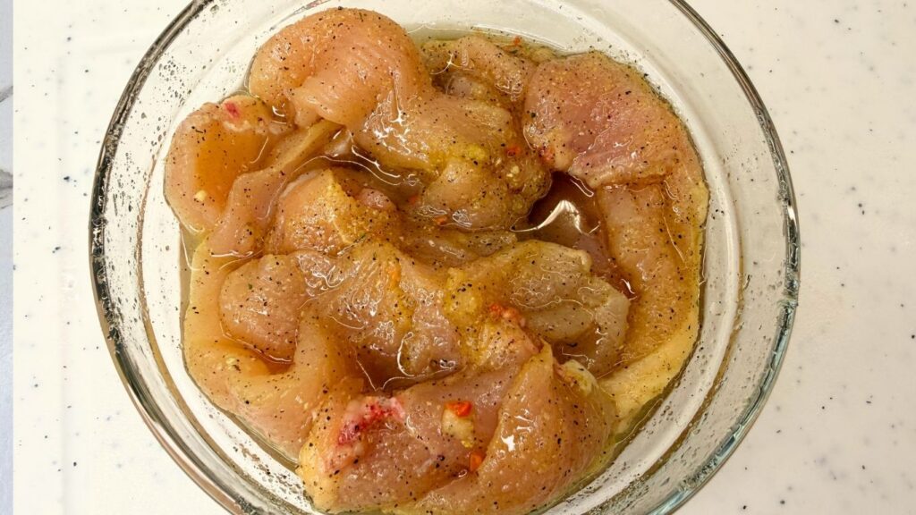 Thinly sliced chicken coated in a seasoned oil marinade for creamy chicken pasta.