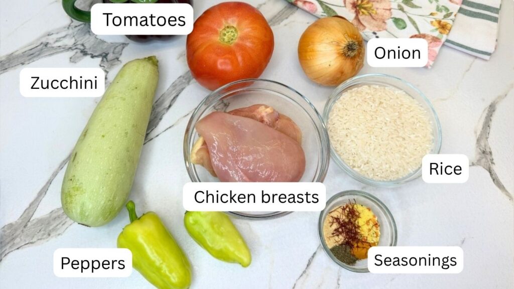 Ingredients for one-pot chicken and rice with vegetables arranged on a kitchen table.