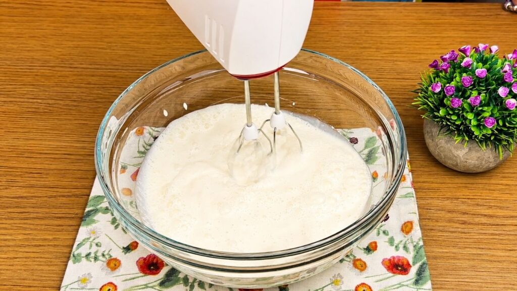 Adding vanilla cream powder to the Oreo filling mixture.