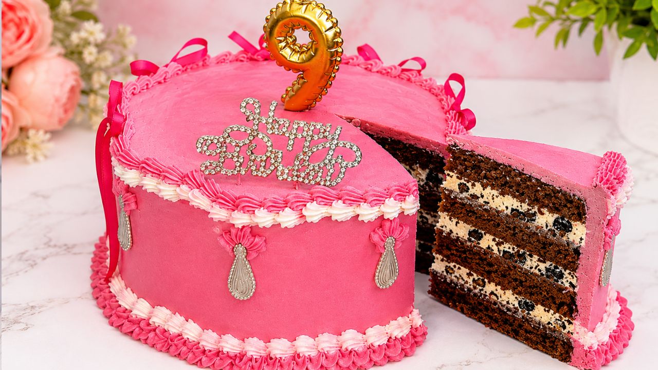 Pink chocolate Oreo cake with Oreo cream filling and sliced chocolate cake layers.
