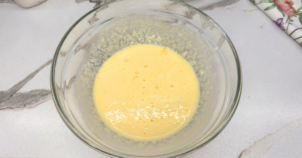 Wet ingredients mixed together in a bowl for strawberry scones.
