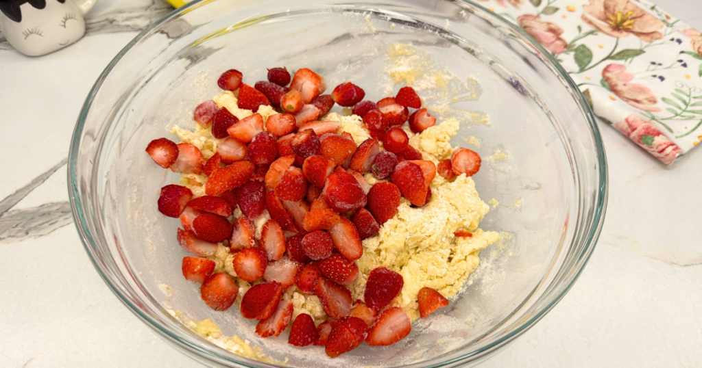 Frozen strawberries added to the mixed strawberry scone dough.