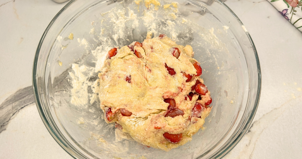 Strawberry scone dough with frozen strawberries chilling in the refrigerator for 10 minutes.
