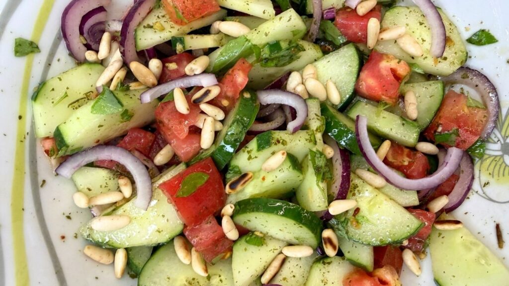 Toasted pine nuts sprinkled over fresh cucumber salad just before serving.