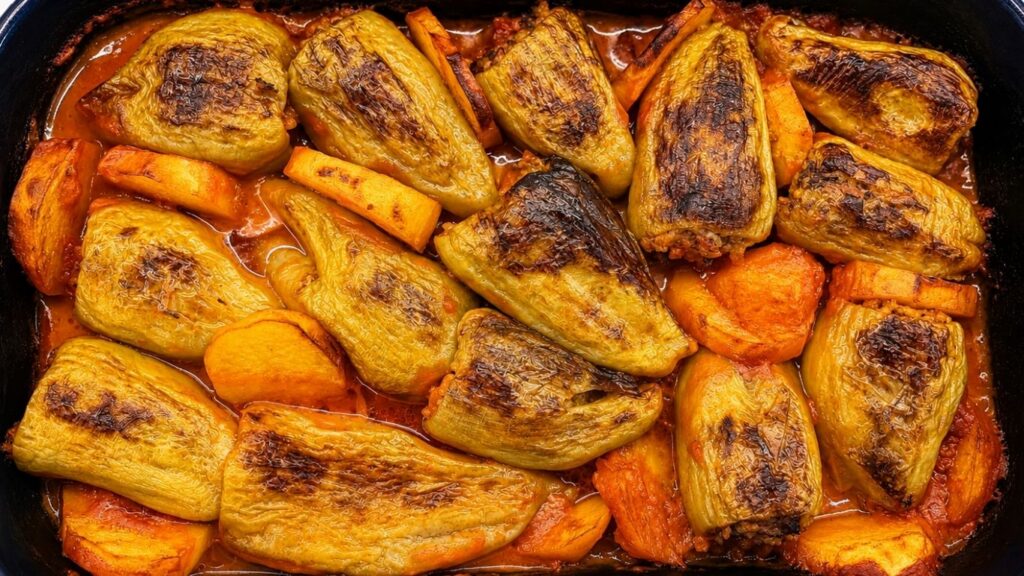 Baked stuffed bell peppers with potatoes in tomato sauce, ready to serve for a homemade stuffed peppers recipe.