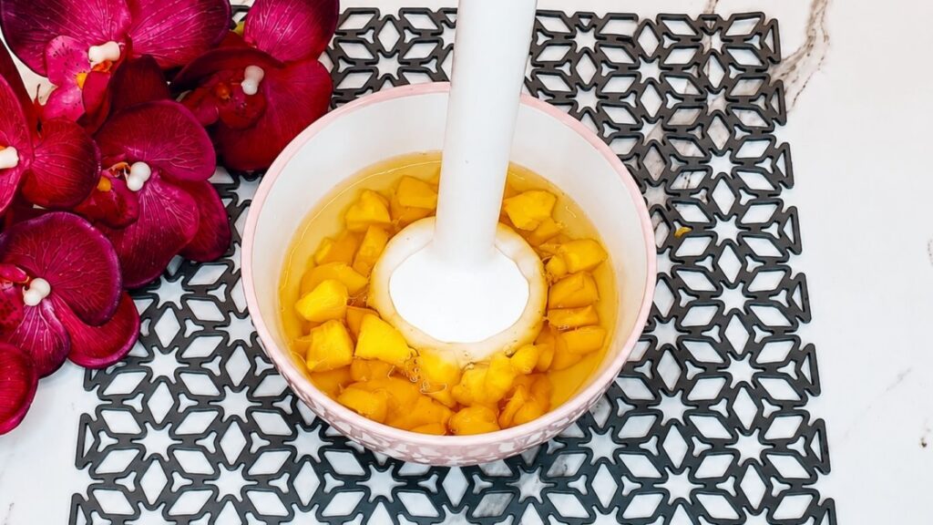 Fresh peaches blended with water to make the peach topping for easy no-bake peach yogurt cake.