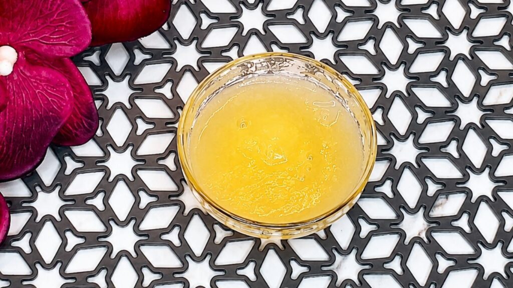 Unflavored gelatin soaking in cold water in a small bowl for easy no-bake peach yogurt cake filling.