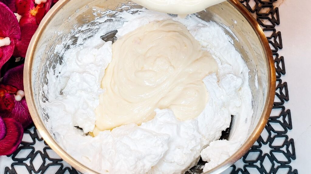 Thick peach yogurt added to fluffy whipped cream for easy no-bake peach yogurt cake filling.
