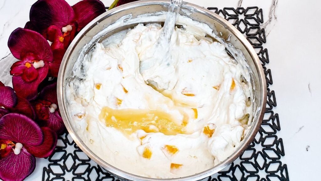 Melted gelatin mixed into the peach yogurt cream filling for easy no-bake peach yogurt cake.