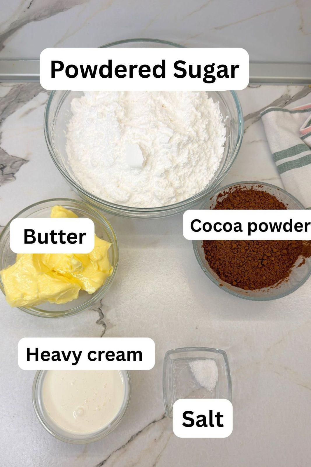 Chocolate buttercream ingredients including butter, powdered sugar, cocoa powder, heavy cream, and salt