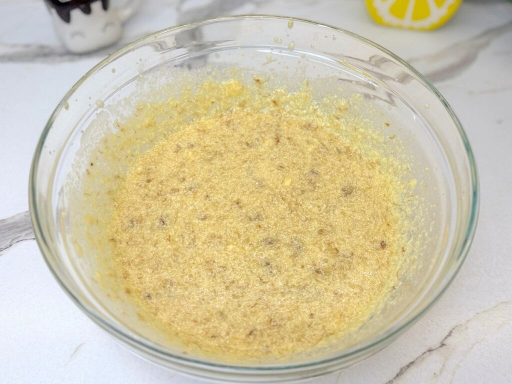 Wet ingredients and mashed bananas combined in a mixing bowl.