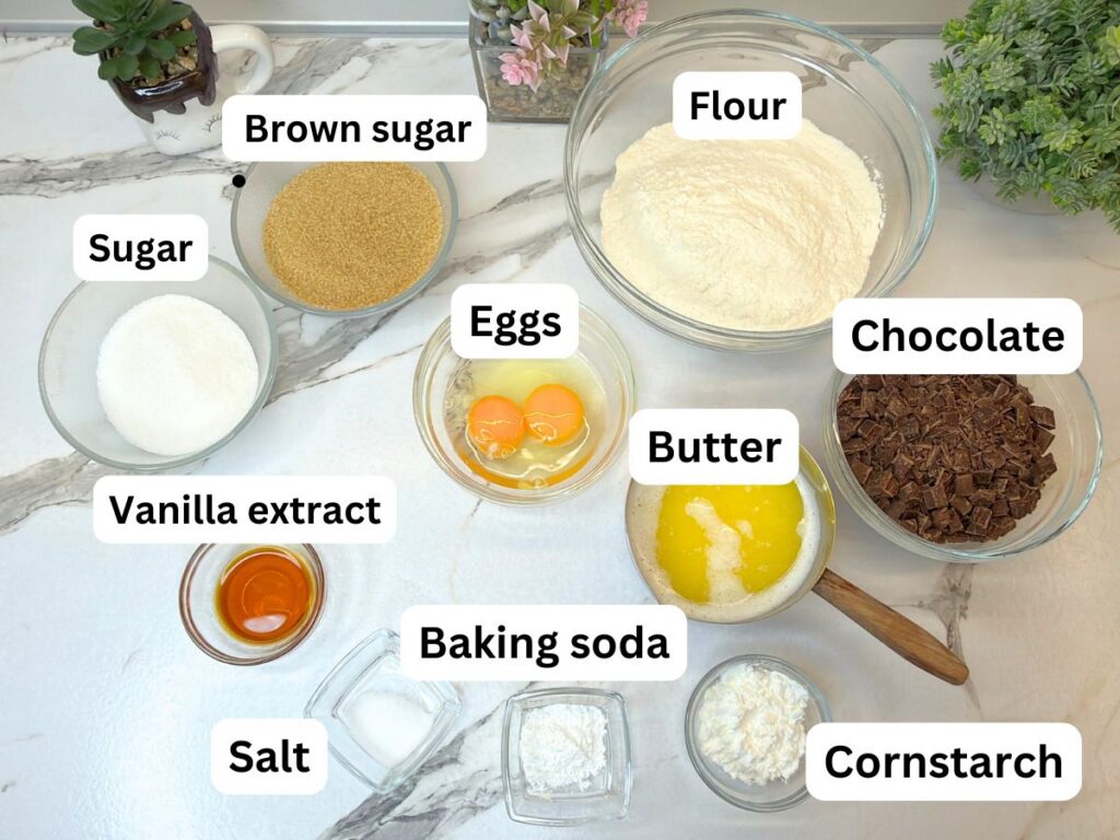 Ingredients for Chocolate Chip Cookie Cake arranged in bowls on the kitchen counter.