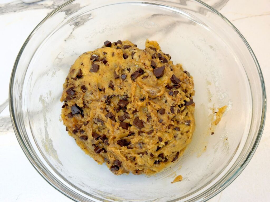 Chocolate chip cookie cake dough with dark chocolate chips evenly mixed in.