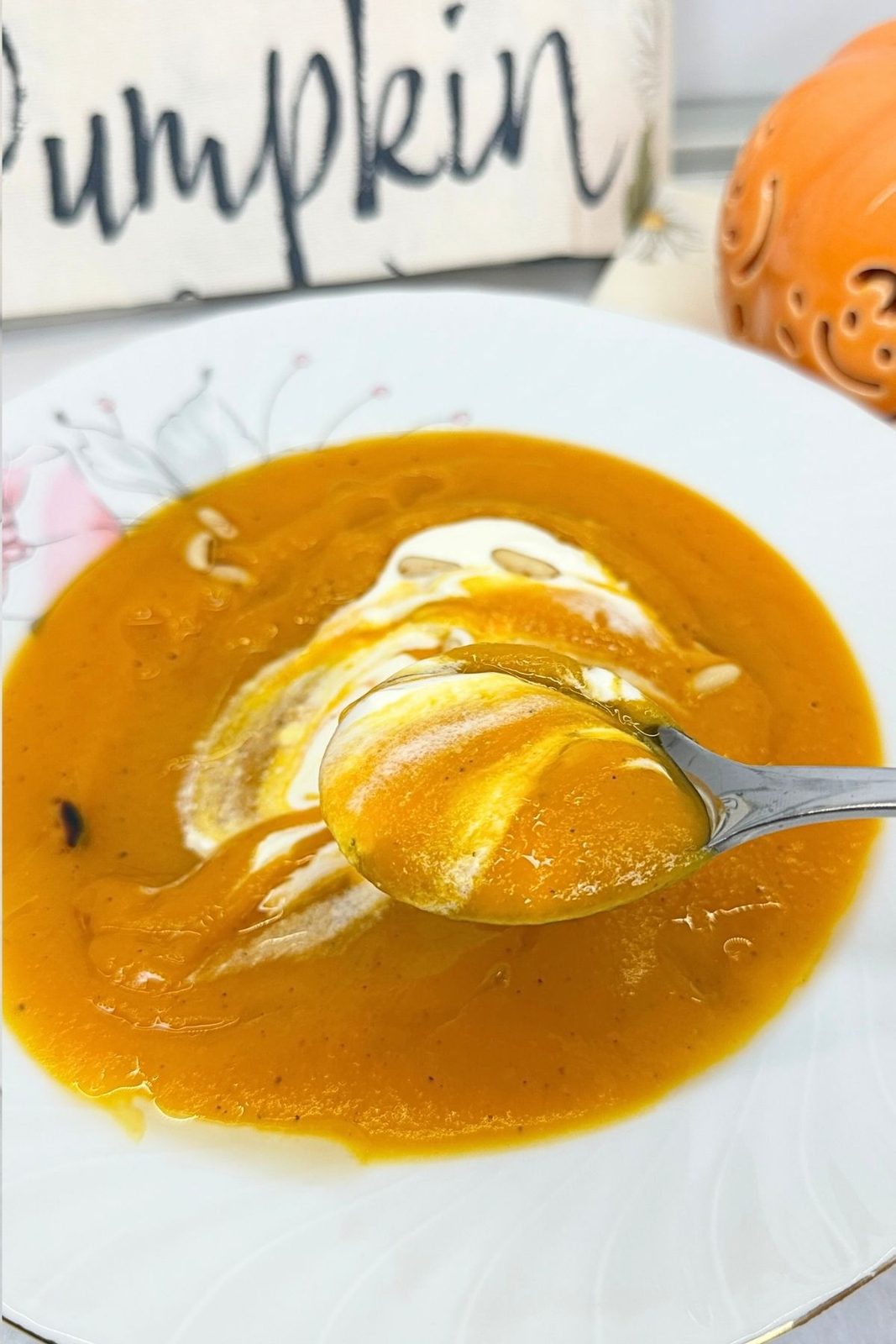 Smooth blended creamy pumpkin soup in a pot with a ladle