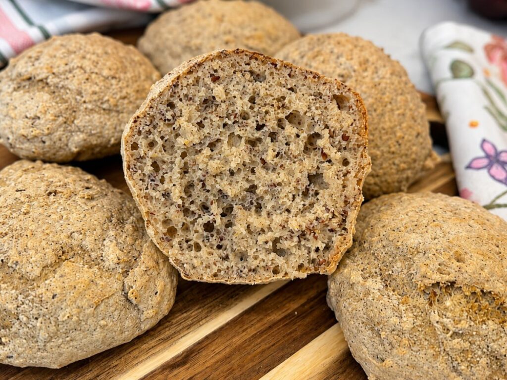 Gluten-Free Multigrain Roll cut open to show its light, airy crumb and flaxseed texture.