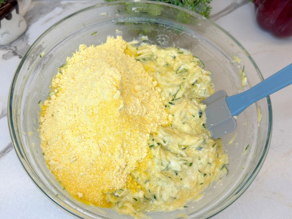 Cornmeal and corn flour added to the wet zucchini muffin mixture.