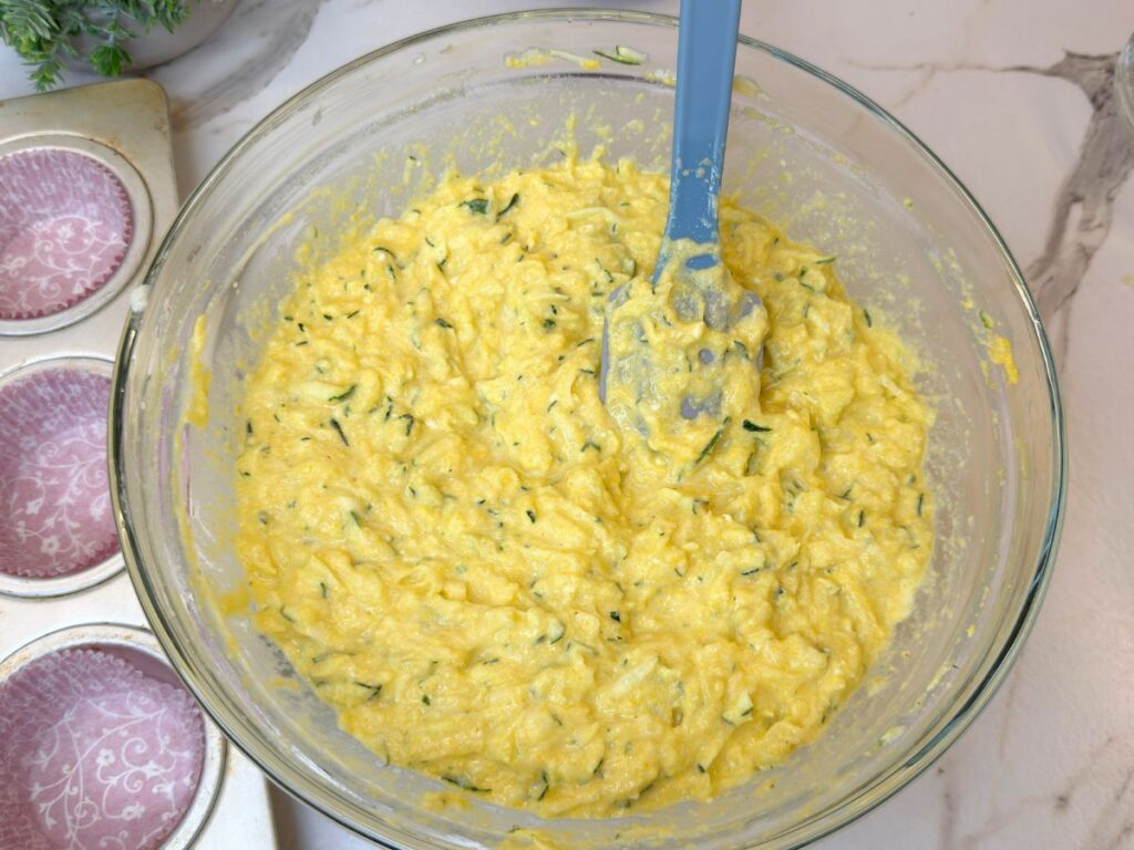 Gluten-free zucchini muffin batter mixed with cornmeal, corn flour, and cottage cheese.