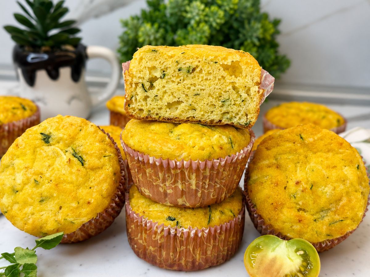 Moist gluten-free zucchini muffins with cottage cheese, served warm on a plate.