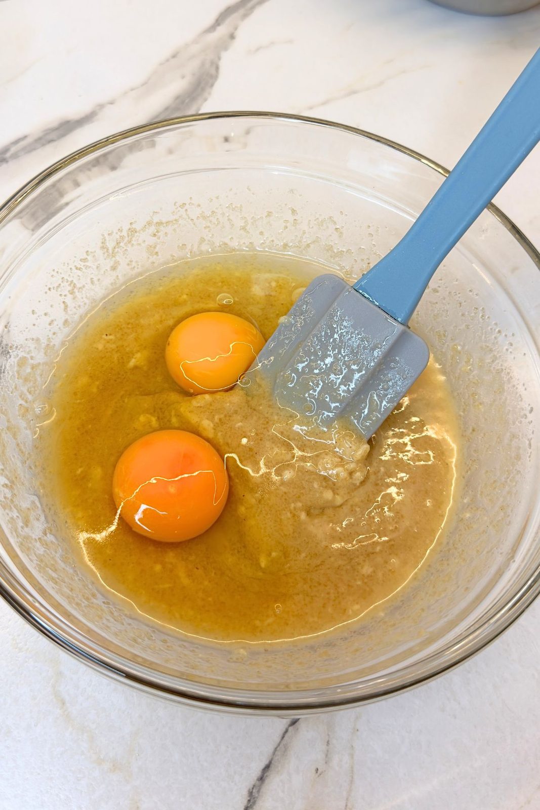 Two eggs added to the almond butter and sugar mixture for gluten-free apple oatmeal cookies