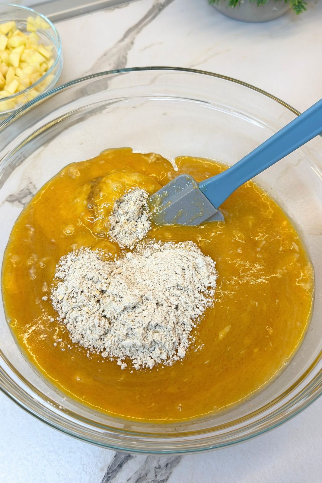 Gluten-free oat flour mixture added to the wet ingredients for apple oatmeal cookie dough