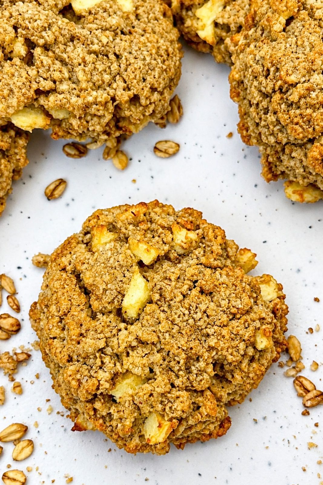 Close-up of a gluten-free apple oatmeal cookie with rolled oats and fresh apple pieces
